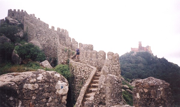 The steep steps forming the path around the edge of the castle, with the Pena Palace in the distance