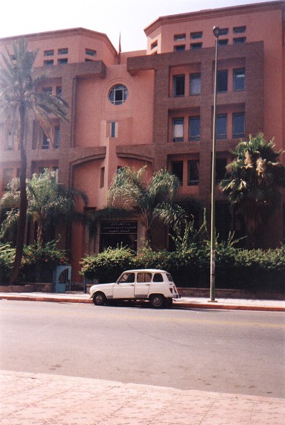 A Renault 4 parked outside one of the more plush buildings in the rich part of Marrakech