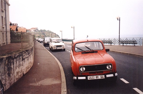 A pair of Renault 4s parked on the cliffs above the beach at Biarritz